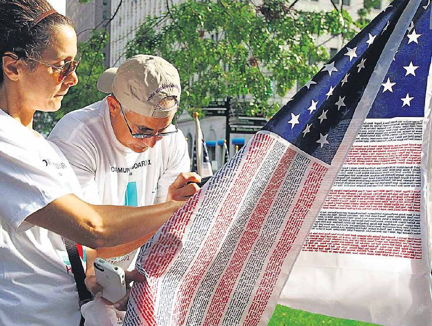 11 settembre 2011 a Manhattan (N.Y., USA): bandiere americane coi nomi delle vittime dell'attentato dell'11 settembre 2001; fonte AFP